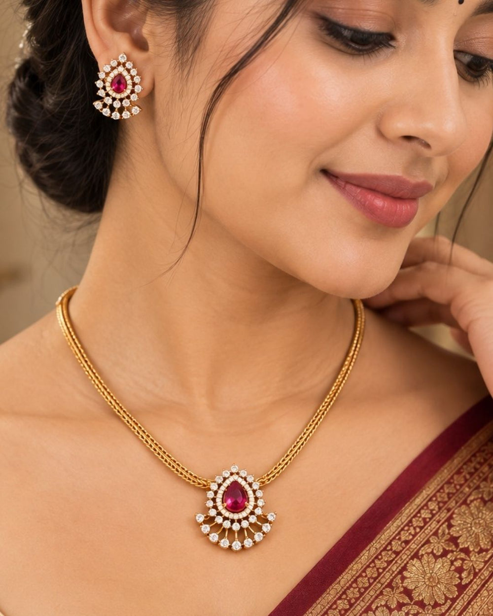 South indian women wearing a pure Zircon diamond gold plated pink ruby teardrop pendant set showing a flat golden chain and matching studs that give a graceful traditional and modern look for daily wear and office gifting with COD.