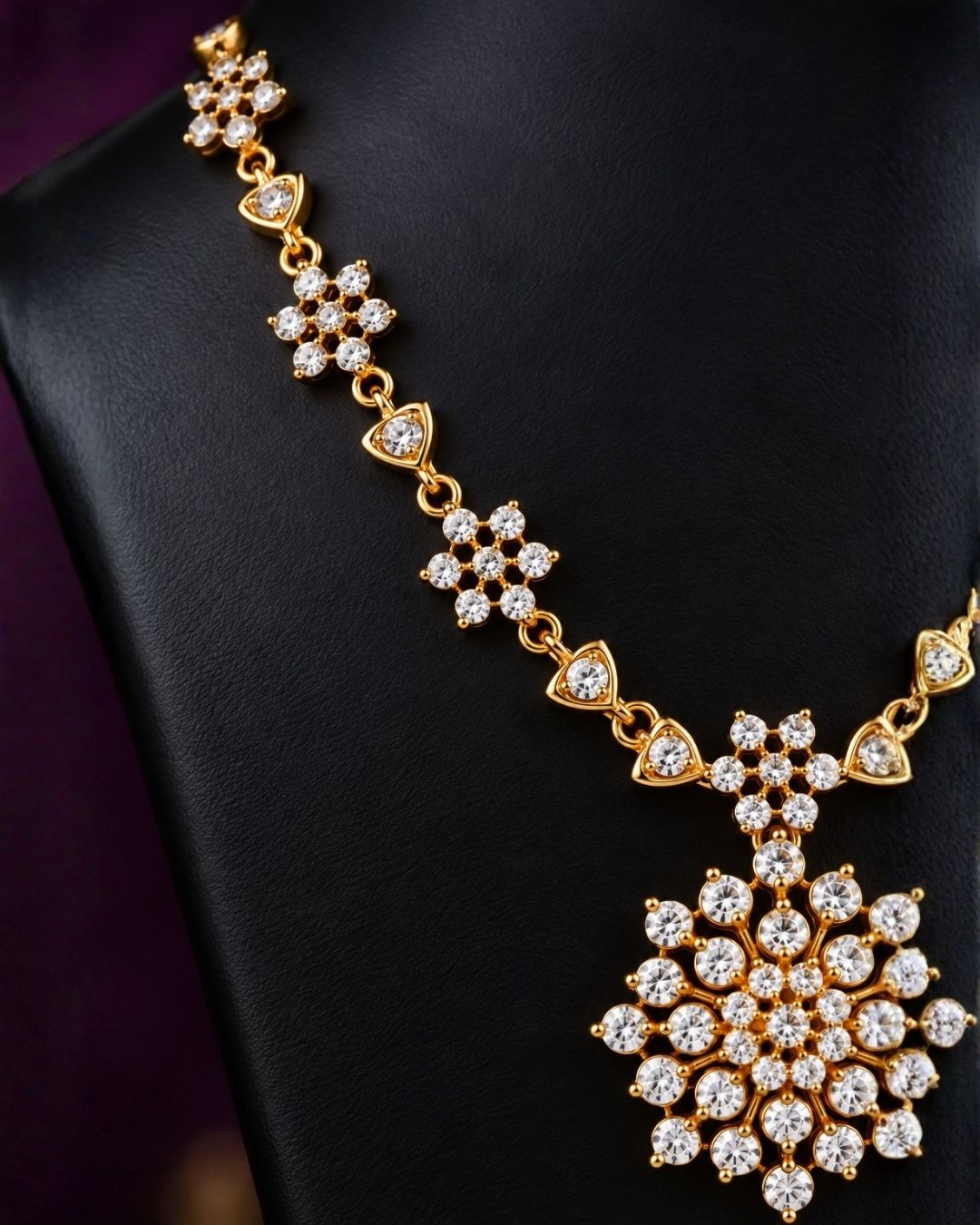 Zircon diamond gold-plated necklace set showcasing an intricate chain linked with tiny floral stone clusters and a beautiful geometric snowflake statement pendant. The matching earrings perfectly mirror the pendant&
