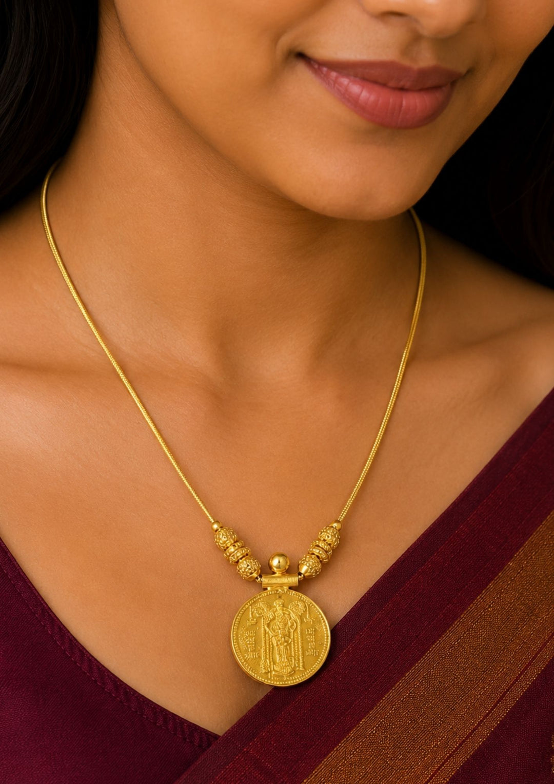 A close-up of a woman wearing a Exquisite God Balaji gold-plated coin necklace featuring intricate motif carvings and ruby-colored stone accents. Ideal for weddings, festive occasions, temple visits, traditional sarees, and bridal gifting.i.