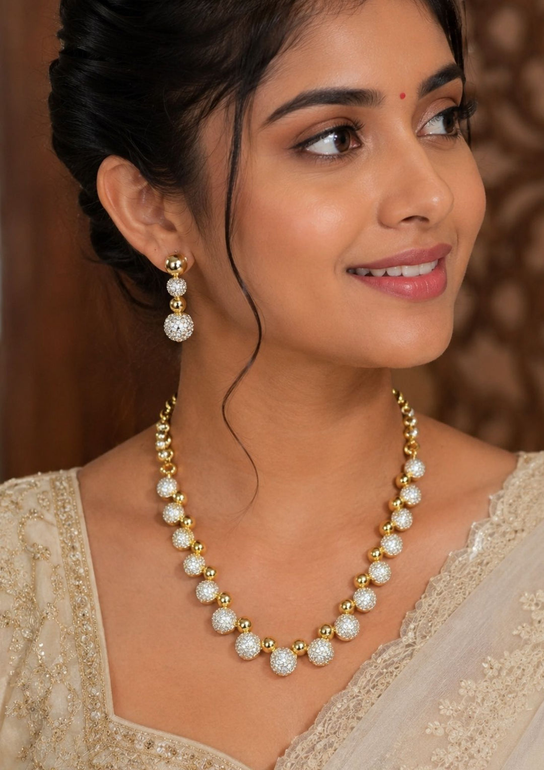 South Indian Woman wearing Gold Plated Zircon Diamond necklace set designed in ball model with some pusalu and it comes with matching earrings perfect for weddings, functions, festivals and it is anti fade color and skin friendly best for gifting