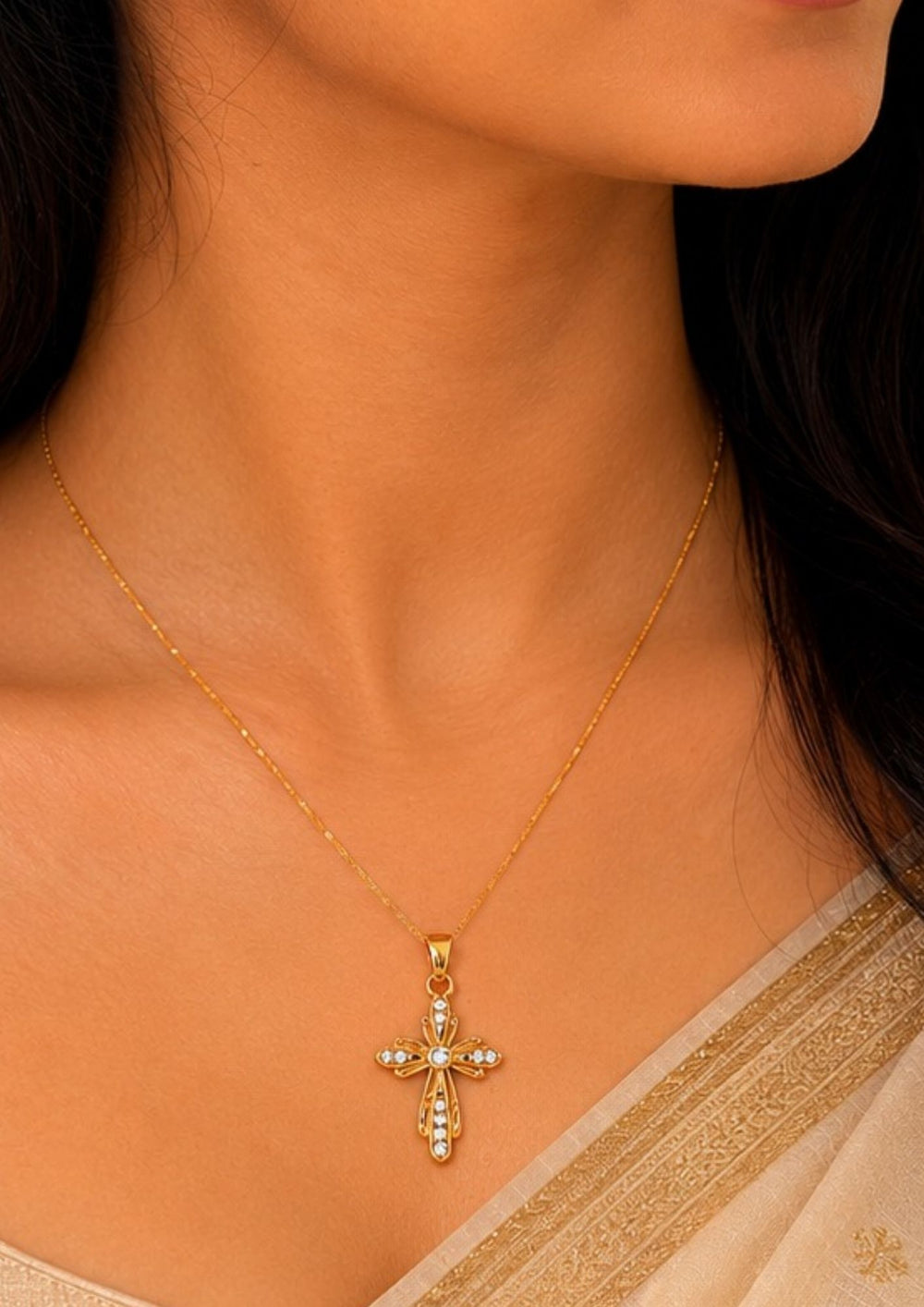 South indian women waering a The cross has a stylized, vintage-inspired design with floriated or flared edges. It is embellished with small, clear sparkling stones (likely cubic zirconia or crystals) set along the arms of the cross and clustered at the center, giving it an eye-catching shimmer.