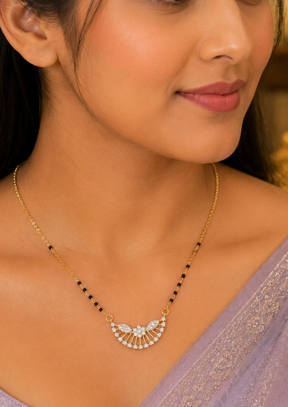 A close-up South indian woman wearing a Gold plated black beads mangalsutra featuring an elegant Semi Curve-inspired zircon centerpiece with delicate curved detailing. Lightweight and beautifully crafted for everyday elegance, festive occasions, and gifting.
