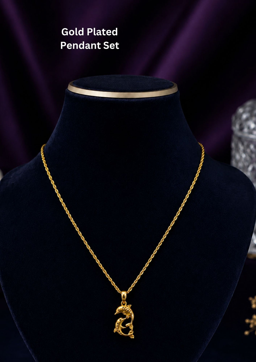 Two dolphins are depicted in a playful, curved position, forming a loose yin-yang or circular shape. The dolphins feature textured detailing along their backs to give them a shimmering, patterned look.