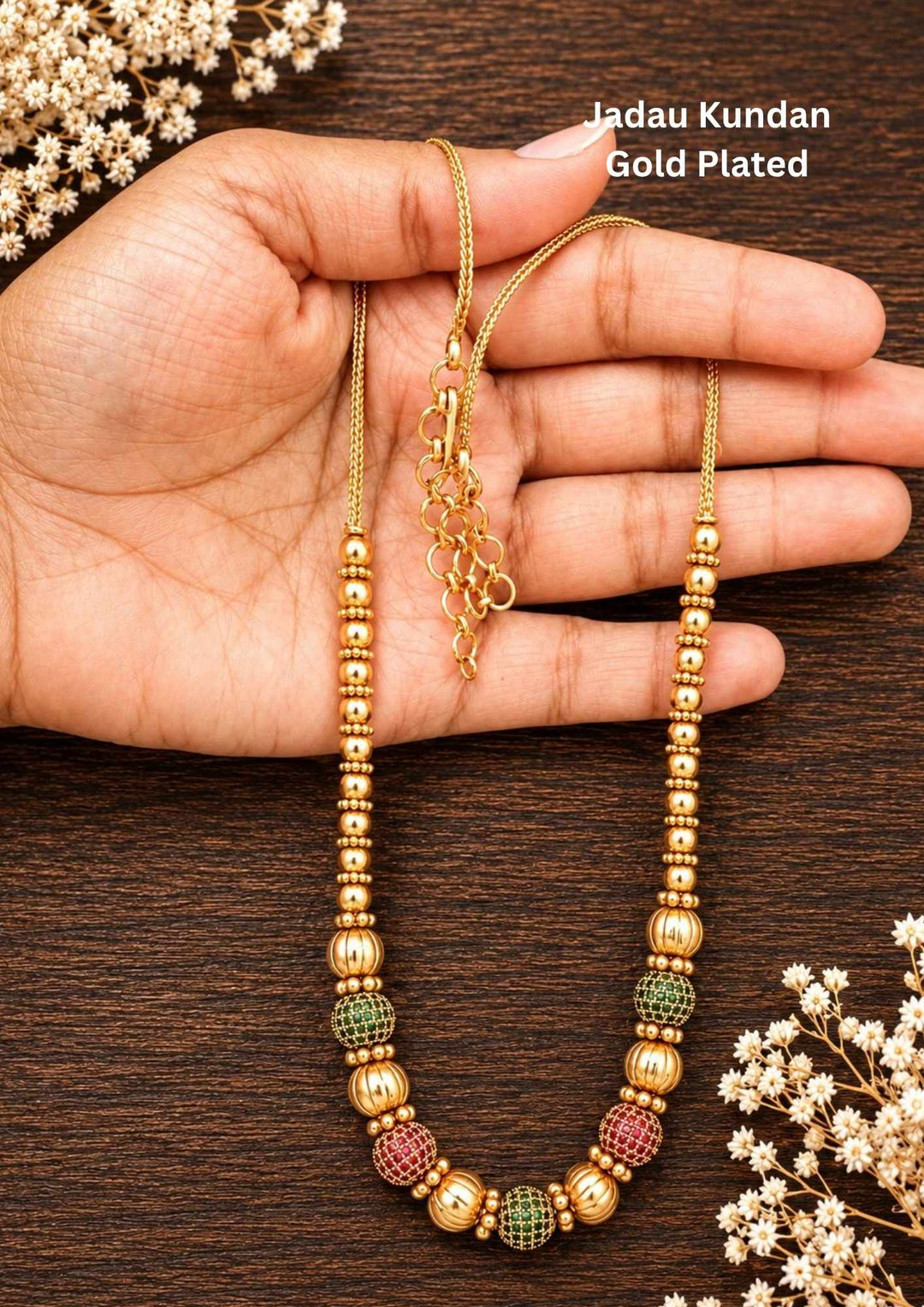 Antique Gold Plated Beads Mala with long traditional chain designed with gold beads , antique finish pattern, and South Indian jewelry style. The mala comes with kundans and green and red stones in cube pattern and balls pattern with green stones . this is sweat proof quality, anti-fade colour, skin-friendly finish, and is suitable for pooja functions, festivals, daily wear, and traditional occasions.