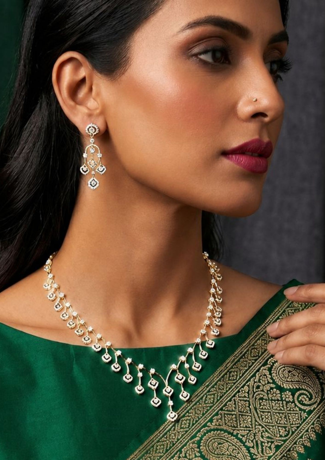 South indian women wearing a simple and elegant gold-plated diamond necklace set. It features shiny, tiny square shapes that look like real diamonds. This jewelry set looks perfect with traditional Indian clothes like sarees, lehengas, or even modern party dresses. It is a great choice for weddings, family functions, festivals, and parties.