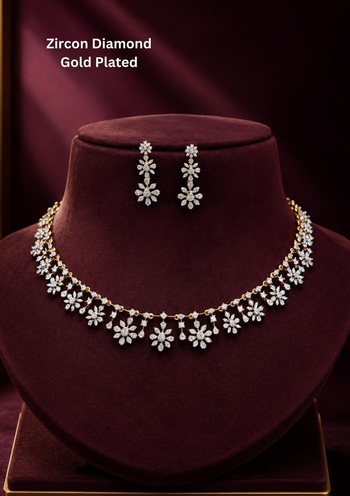 Gold-plated zircon diamond necklace and earrings designed with floral pattern and tear drop in between the florals perfect for weddings, parties, functions.