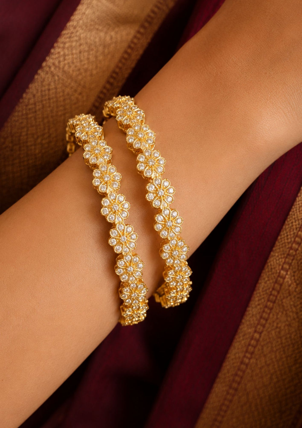 Close up of South indian women wearing A pair of gold-plated bangles decorated with clear zirconia stones in a floral pattern, Beautiful zircon diamond gold plated floral bangles featuring continuous sparkling flower motifs and premium craftsmanship. Perfect for weddings, festivals, parties, and elegant everyday styling.
