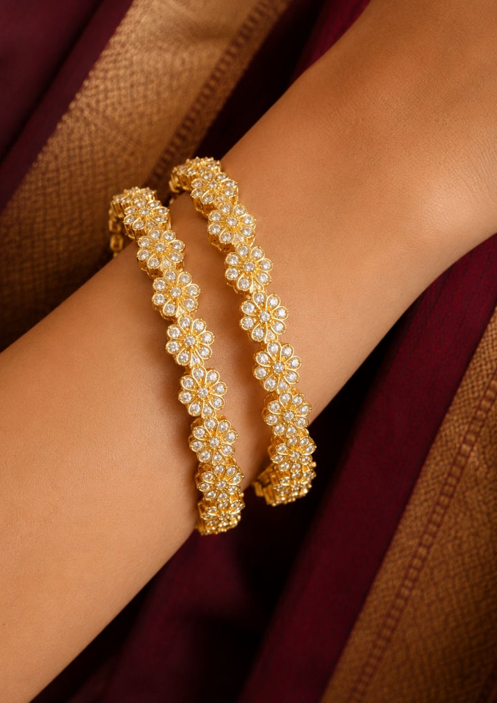 Close up of South indian women wearing A pair of gold-plated bangles decorated with clear zirconia stones in a floral pattern, Beautiful zircon diamond gold plated floral bangles featuring continuous sparkling flower motifs and premium craftsmanship. Perfect for weddings, festivals, parties, and elegant everyday styling.