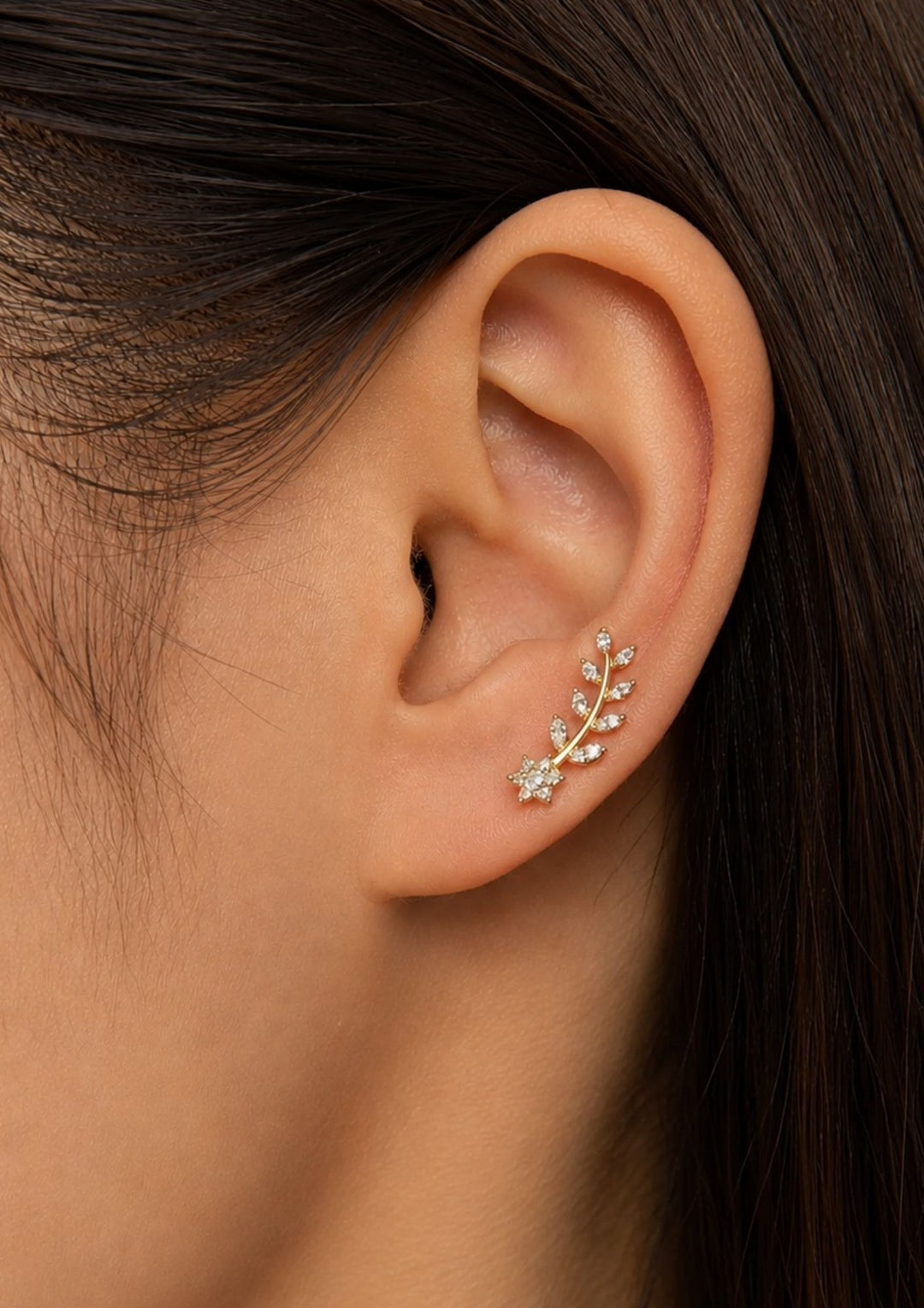 Close-up of an south indian women ear wearing Zircon Diamond Gold Plated Leaf Model Ear Studs it is very simple studs and looking very classy and can use for office wear and daily ware skin safe and anti fade 