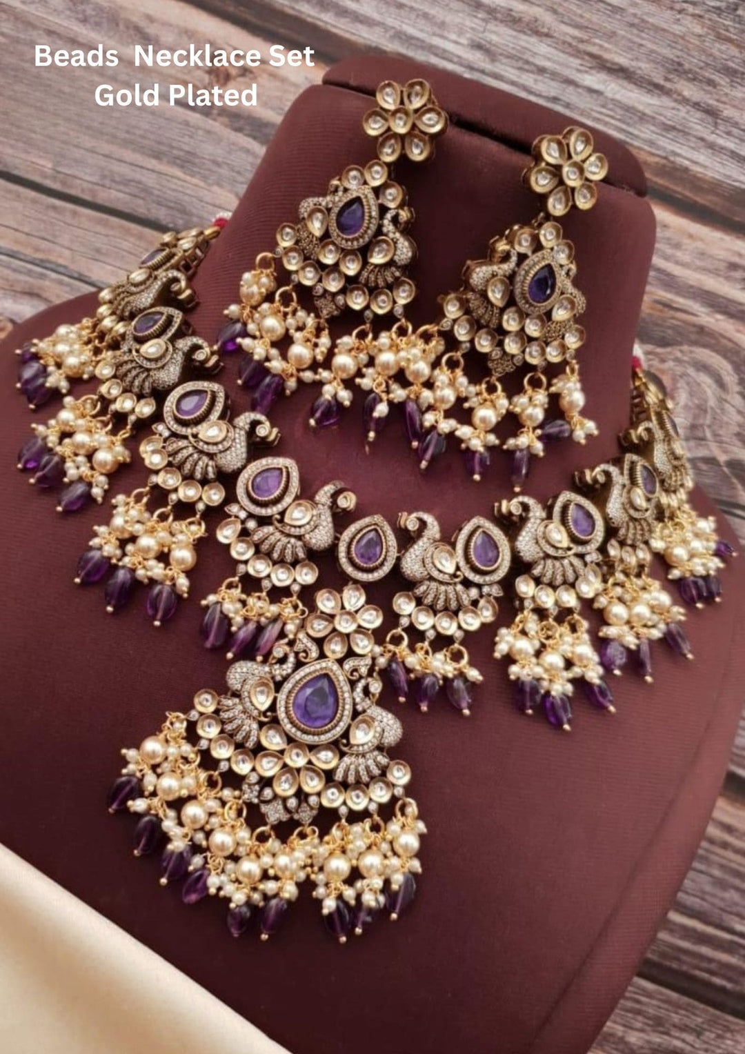 gold-colored kundan and beads necklace with matching earrings, featuring purple beads.