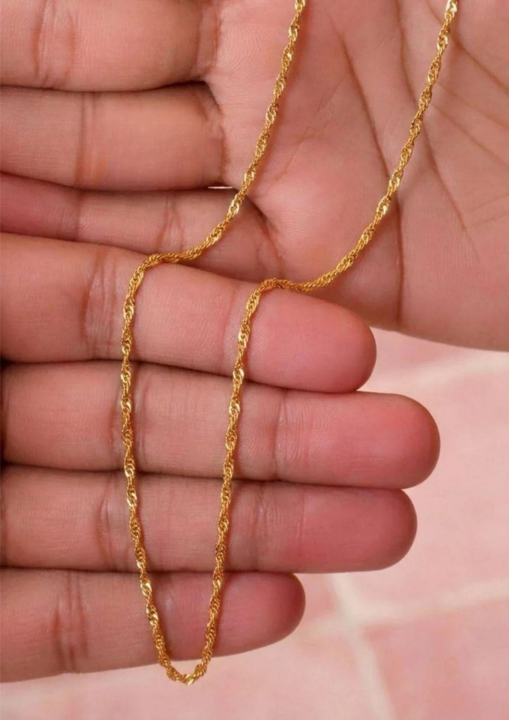 A close-up of a gold-colored twisted rope chain necklace perfect for dailywear