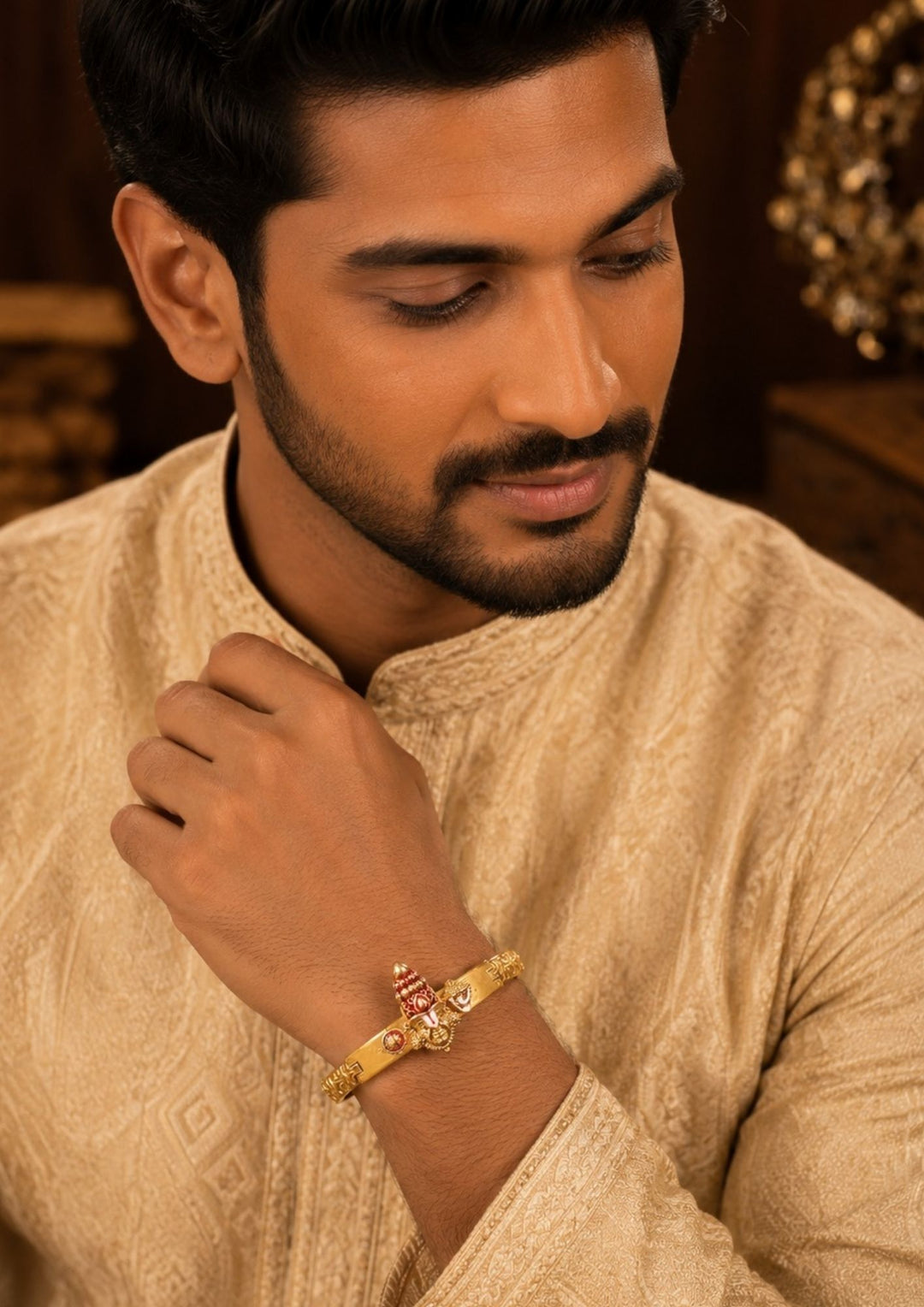 South Indian man styling a gold plated Balaji design bracelet with traditional and ethnic outfits. The bracelet features temple-inspired craftsmanship, embossed detailing and an adjustable secure clasp that adds a bold and devotional touch to festive and everyday styling.