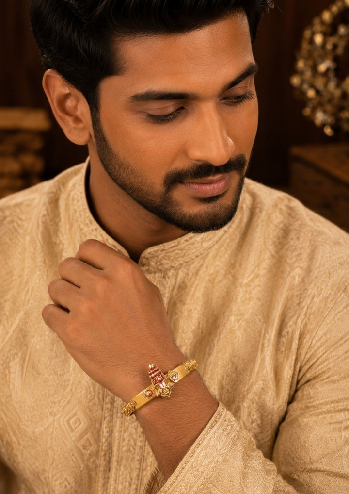 South Indian man styling a gold plated Balaji design bracelet with traditional and ethnic outfits. The bracelet features temple-inspired craftsmanship, embossed detailing and an adjustable secure clasp that adds a bold and devotional touch to festive and everyday styling.