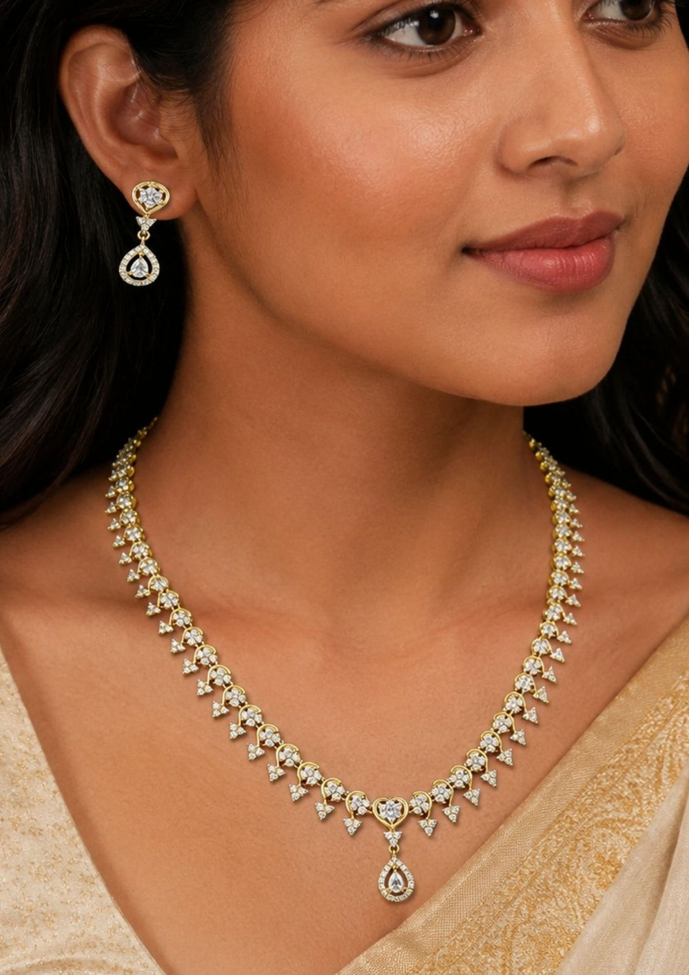 South indian Woman wearing a traditional gold plated festive choker necklace featuring a repeating cluster arrangement of vibrant ruby-red and emerald-green stones shaped into floral and paisley motifs. The structured collar aligns closely with a pair of matching floral stone-set ear studs perfect for weddings, bridal wear, receptions, office and it comes with anti tarnish , anti color fade and skin friendly