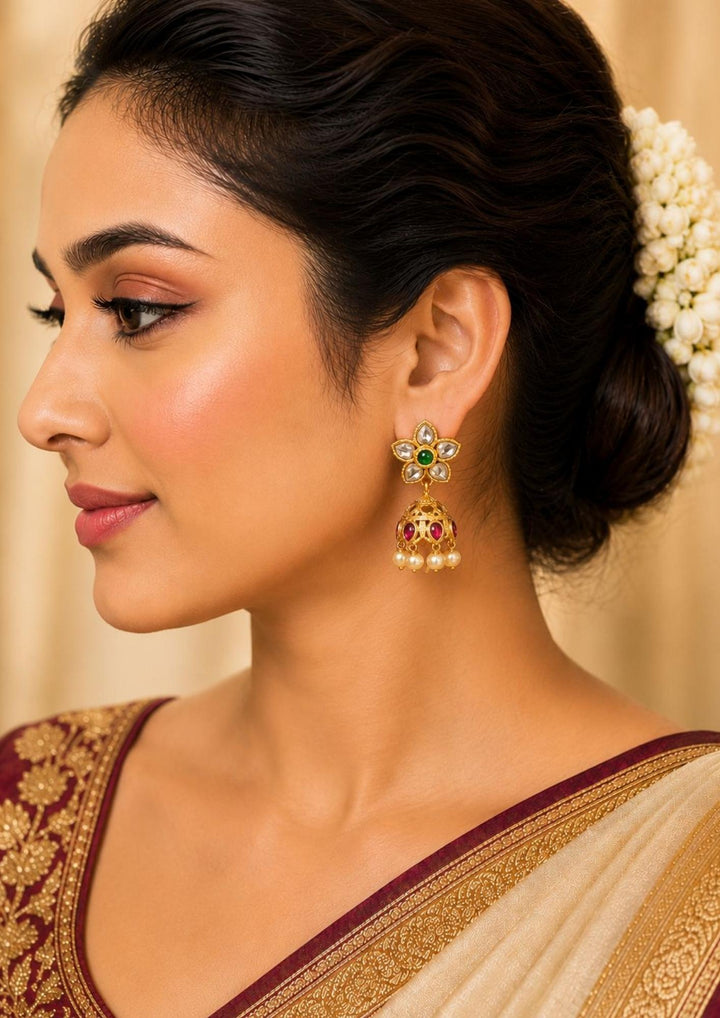 South indian women waering a Gold plated earrings with gemstones and pearls jhumaks with waterproof, anti fade used for dailyware ,festivals weddings, and ideal for gifting.