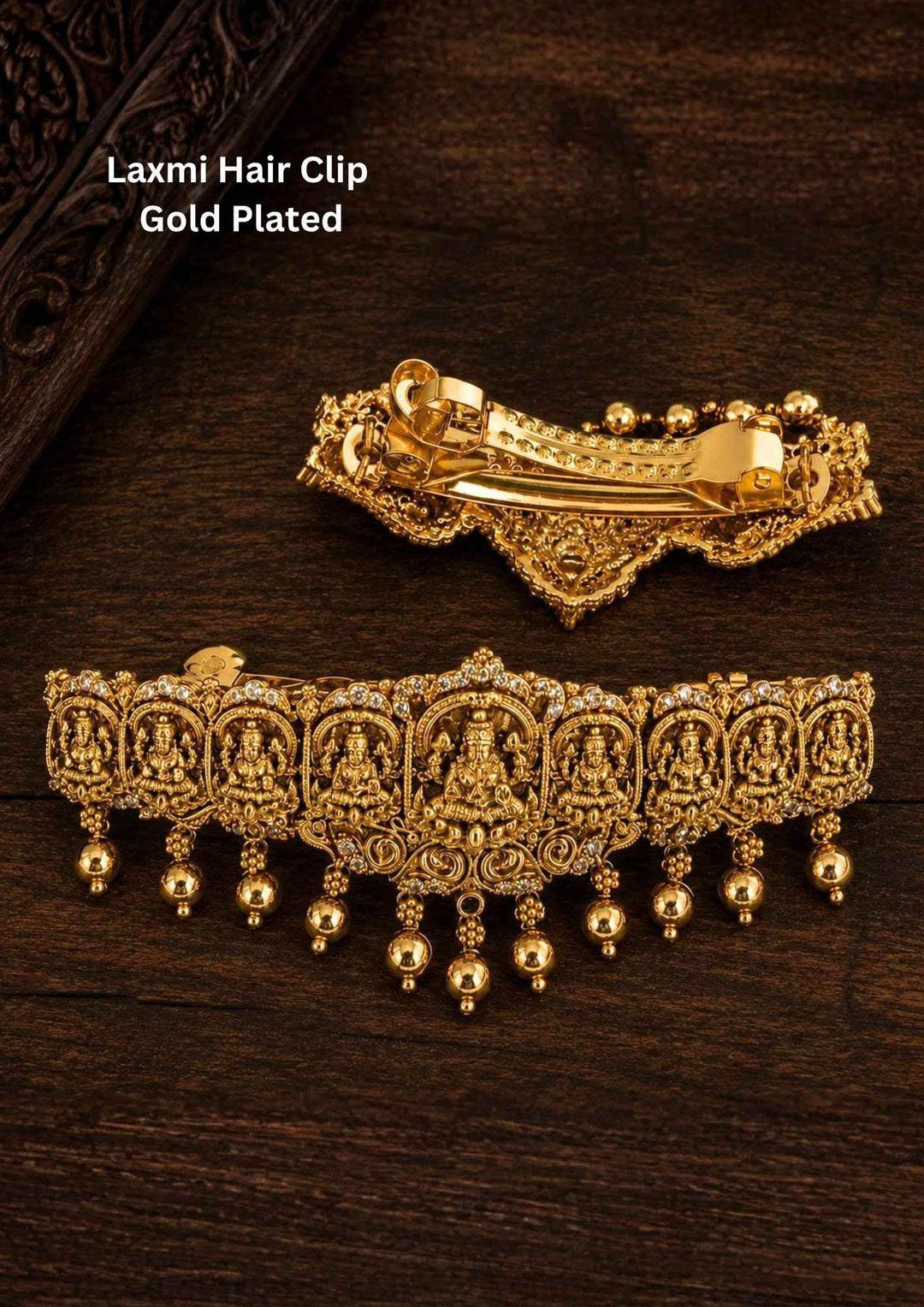 Laxmi gold plated hair clip designed with goddess Lakshmi in antique temple jewelry design, shining with white stones and hanging gold bead drops, with metal clip closure, suitable for bridal hairstyles, weddings, festivals, poojas, Bharatanatyam, sarees, lehengas, and traditional South Indian ethnic hair styling with rich royal appearance.