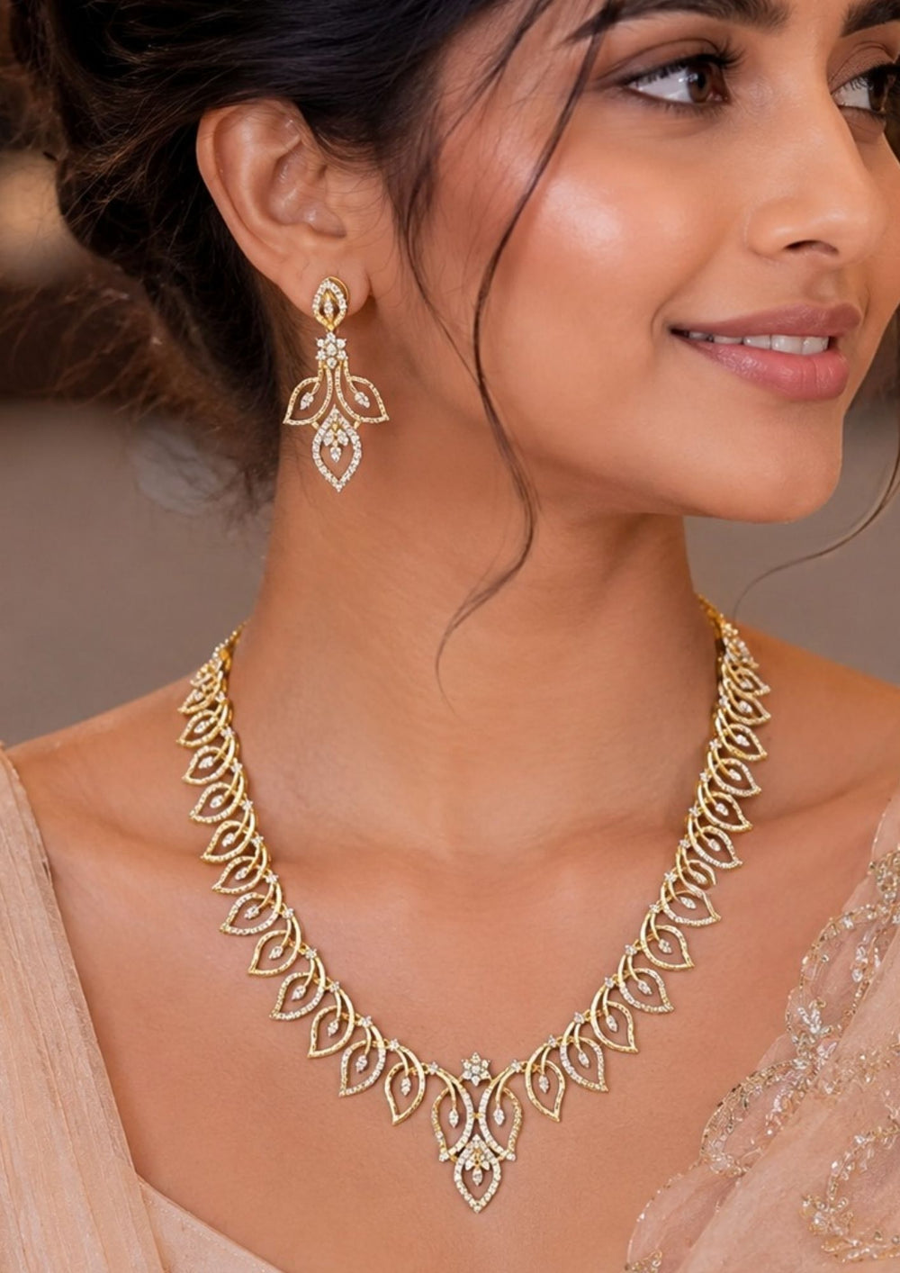 South Indian Woman wearing a Elegant zircon diamond gold plated necklace set featuring a detailed leaf inspired pattern with sparkling white zircon stones arranged throughout the chain and center pendant. The matching designer earrings have a floral leaf drop design with shimmering diamond look stones, creating a graceful modern ethnic style suitable for weddings, receptions, parties and festive occasions.