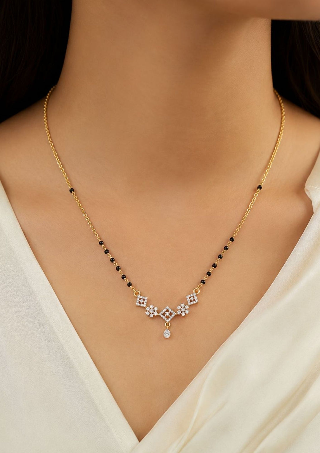 Gold necklace with black beads and a diamond pendant Pure Zirconian Diamond Gold Plated Floral Mangalsutra design in daimoond patteren with floral studs in between hem with pearl drop hanging. perfect for dailywear, offices.