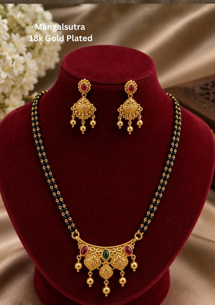 Beautiful 18K gold plated mangalsutra set featuring traditional double black bead chains, decorative pendant, and matching earrings. Lightweight, elegant, and perfect for daily wear, weddings, and traditional occasions.