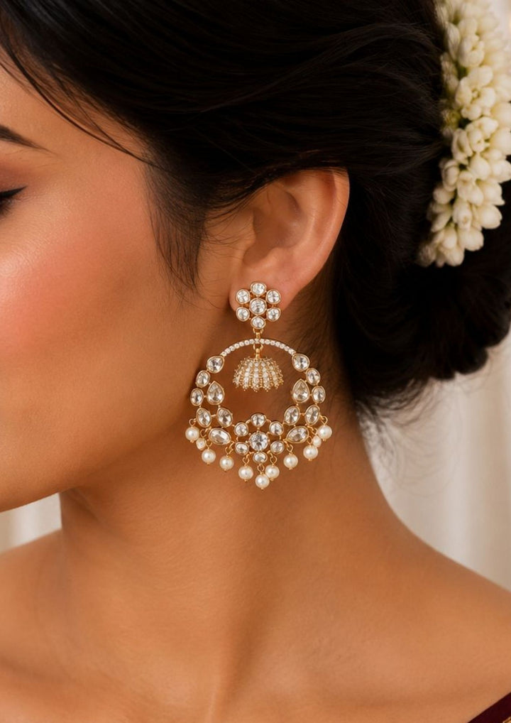 South indian women weaing Zircon diamond gold plated white Chandbali Long Earrings with hanging guttapusalu design, sparkling white zircon stones, floral pattern detailing, and elegant layered arrangement finished with shiny gold plating. The earrings come with lightweight, sweat proof quality, anti-fade colour, skin-friendly finish, and are suitable for weddings, receptions, festivals, functions, and party wear .