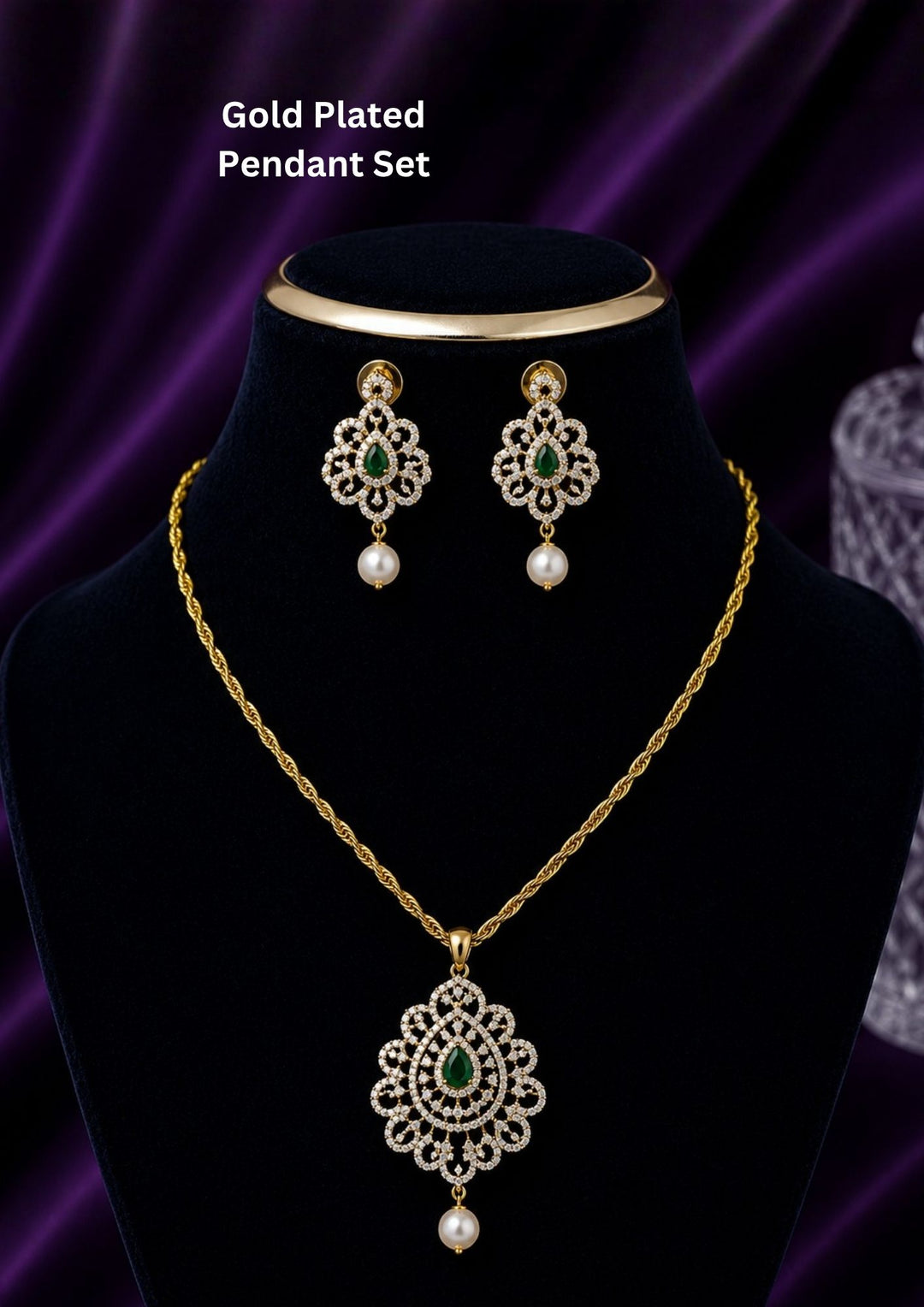 Elegant zircon diamond gold plated pendant set featuring a floral-inspired pendant designed with sparkling white zircon stones arranged in circular patterns. The centerpiece showcases a pear-shaped emerald green stone surrounded by dazzling zircon stones, finished with a delicate pearl drop. The matching earrings mirror the same floral design with green stone and pearl danglers, Perfect for weddings, festivals, office wear, functions and its anti fade color
