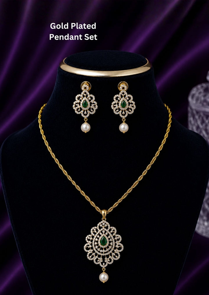 Elegant zircon diamond gold plated pendant set featuring a floral-inspired pendant designed with sparkling white zircon stones arranged in circular patterns. The centerpiece showcases a pear-shaped emerald green stone surrounded by dazzling zircon stones, finished with a delicate pearl drop. The matching earrings mirror the same floral design with green stone and pearl danglers, Perfect for weddings, festivals, office wear, functions and its anti fade color