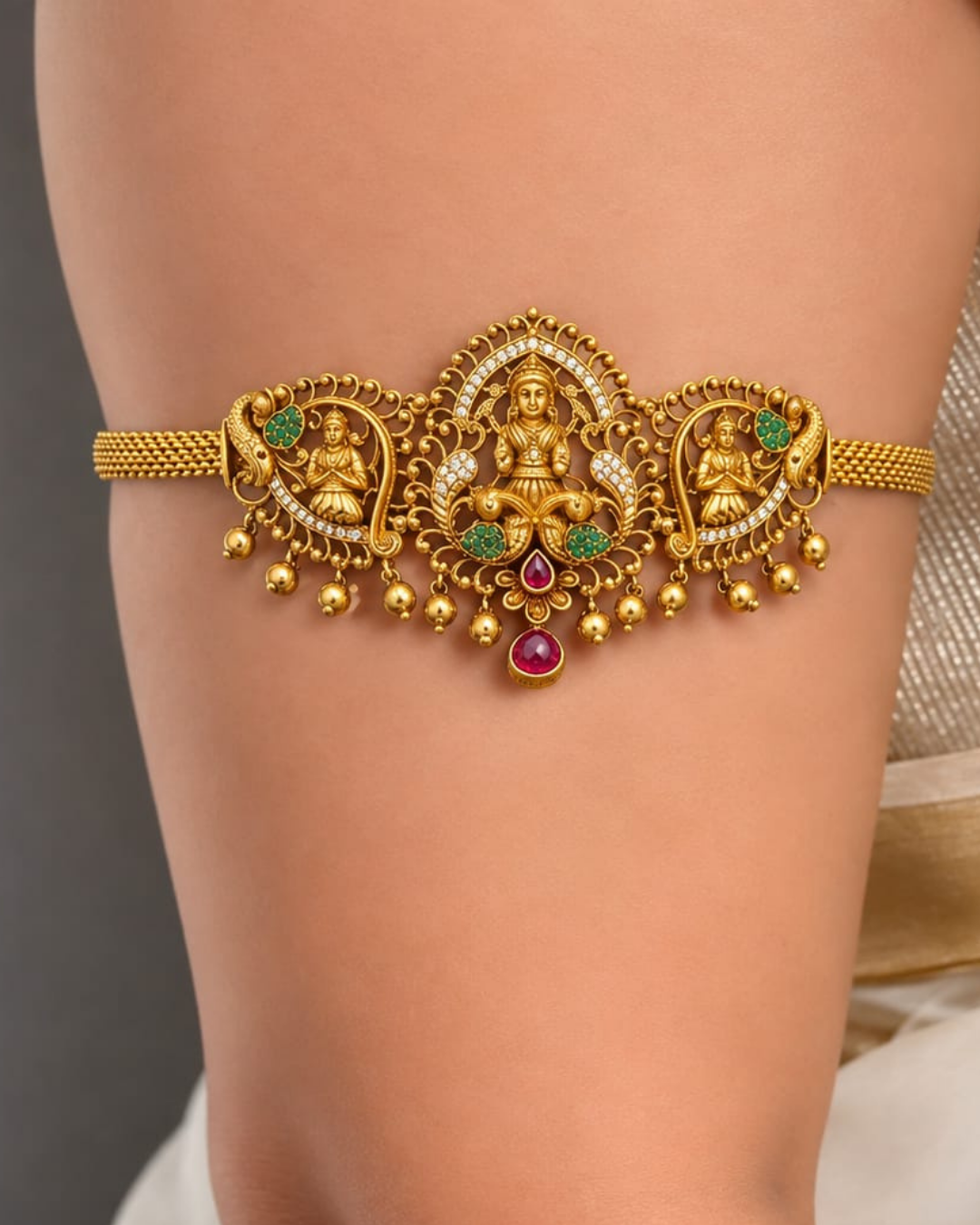 Shop Gold Plated 2-in-1 Choker &amp; Bajuband featuring an elegant Goddess Lakshmi centerpiece, intricate peacock motifs and green-pink stone detailing. Perfect for weddings, festivals, traditional wear and special occasions. COD available at Zevana.