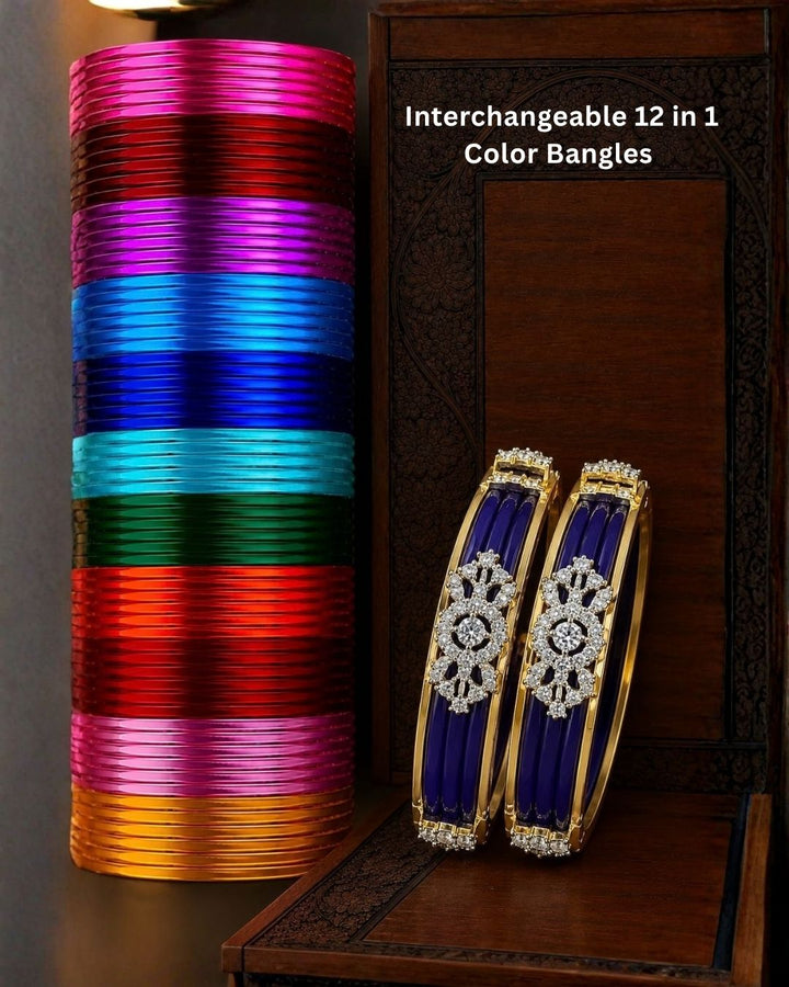 Designer gold plated bangles featuring deep blue detailing, sparkling white stone floral motifs, and polished gold borders, perfect for festive, wedding, traditional, and special occasions.