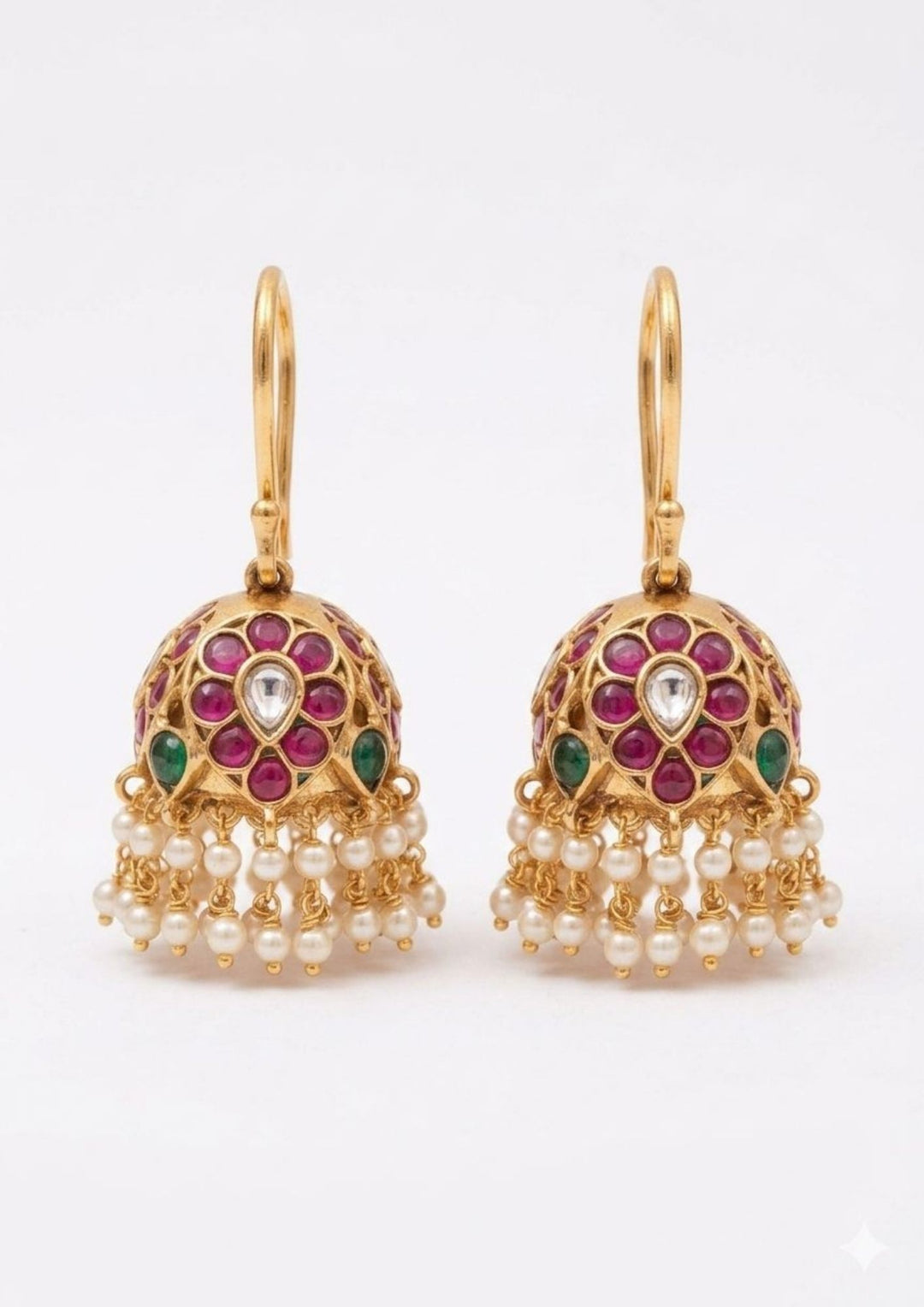 Gold earrings with red and green gemstones on a white background shows very clear picture in traditional look can be used for festivals, weeding's and can gift  