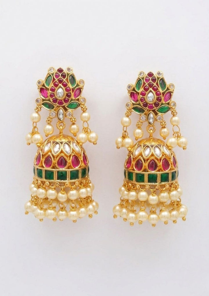 heavy Jadau Kundan Jhumka Earrings with large lotus flower-shaped stud design, dome-style buttalu jhumka pattern, colorful kempu stones, and  with traditional guttapusalu detailing. The earrings give a grand bridal and festive jewelry look with lightweight comfort, sweat proof quality, anti-fade colour, skin-friendly finish, and are suitable for weddings, receptions, festivals, and party wear.