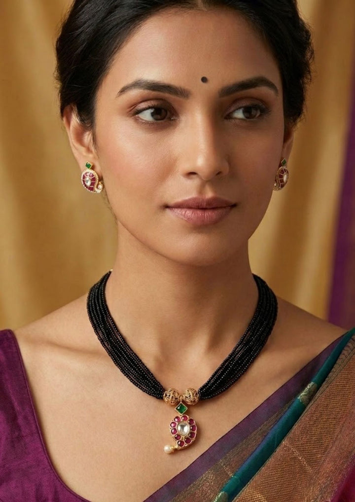 Detailed close-up view of the daily wear 18k gold plated American diamond mangalsutra set. The skin-friendly, anti-fade light mangalsutra chain and stud earrings offer a minimalist traditional look that pairs perfectly with modern western formal shirts, daily wear kurtis, and festive outfits.
