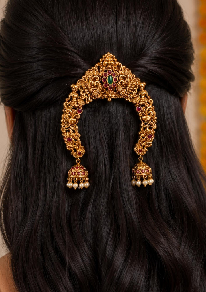 South Indian Women wearing a gold plated floral hair accessories comes with beads and peacock design and shown clearly how it looks jewelry looks so detailed and can be used for bridal ware, functional and festivals 