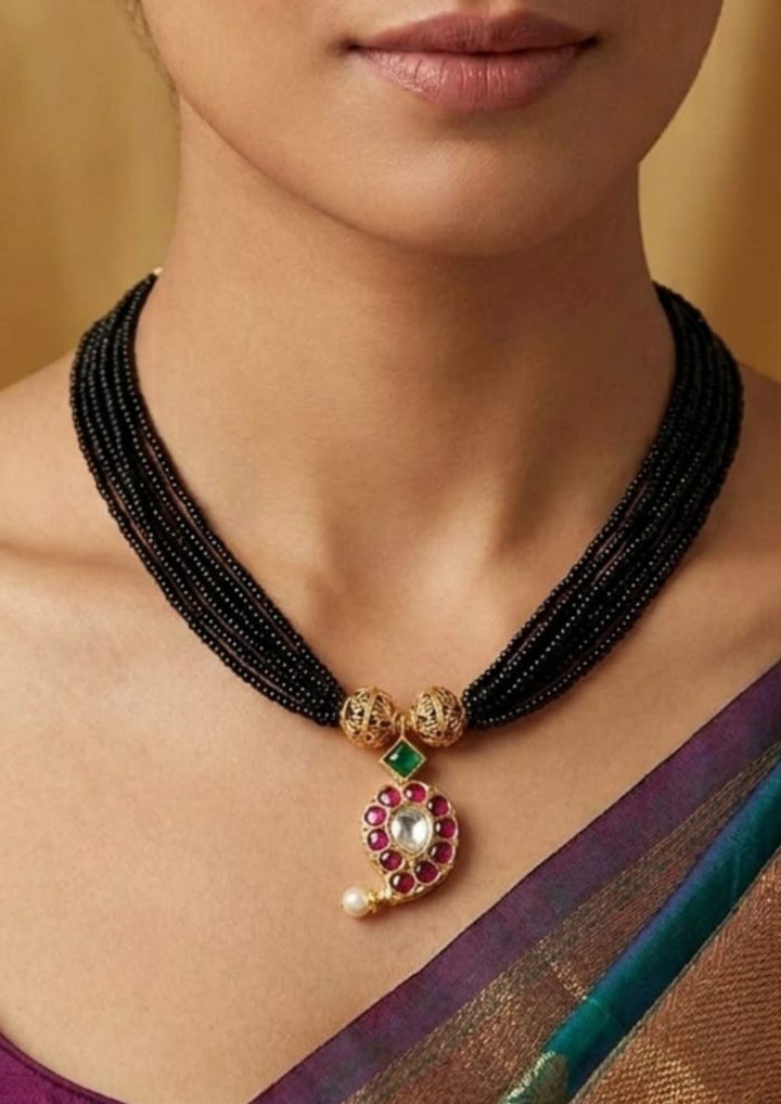 Detailed close-up view of the daily wear 18k gold plated American diamond mangalsutra set. The skin-friendly, anti-fade light mangalsutra chain and stud earrings offer a minimalist traditional look that pairs perfectly with modern western formal shirts, daily wear kurtis, and festive outfits.