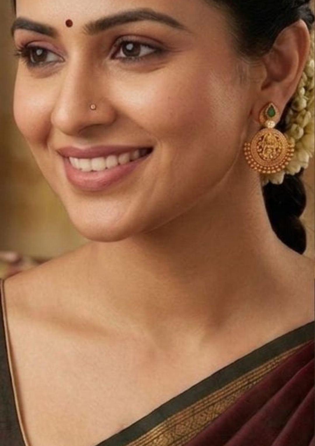 South Indian woman wearing loaxmi devi gold plated earring  and indain women's can ware for weeding's ,  festivals and daily wear