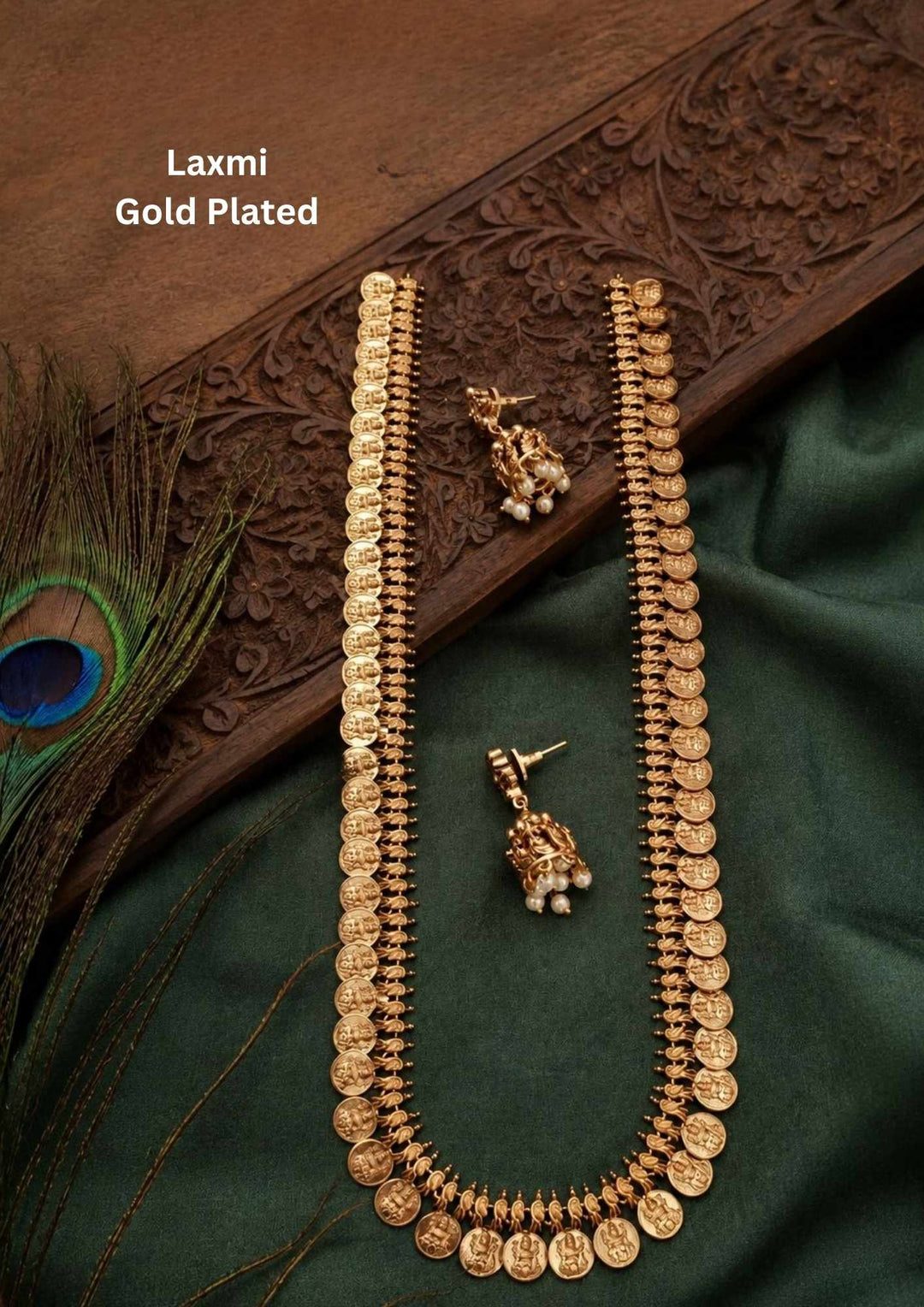 Antique gold plated temple jewelry choker necklace and matching small stud earrings set featuring an intricate central Goddess Laxmi motif flanked by detailed floral and leaf panels. The structured band is adorned with clusters of tiny red ruby stones and delicate hanging gold bead drops suitable for family gatherings, festivals, parties, and weddings with skin friendly quality, anti fade polish, comfortable fitting,
