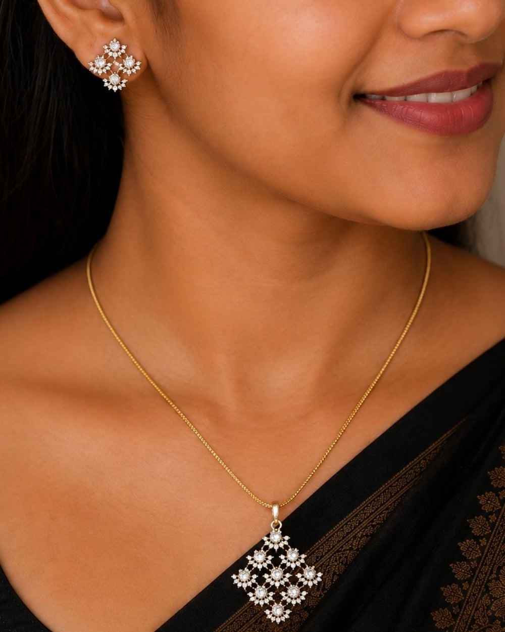 Gold plated chain set featuring a delicate floral-inspired square pendant with sparkling clear stones and matching floral stud earrings.
