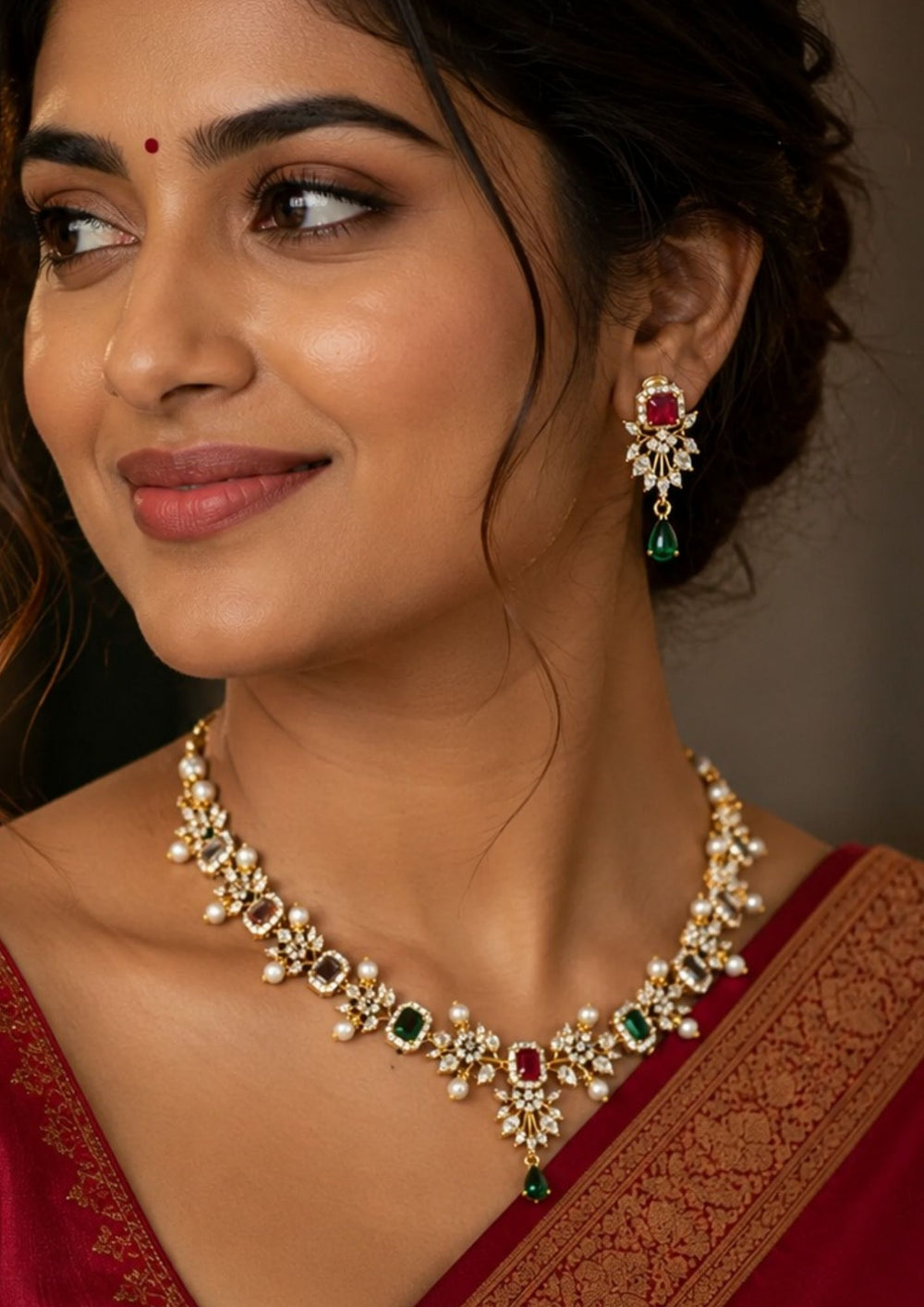 South Indian Woman wearing a Gold-plated necklace and earrings with Navratana gemstones and comes with zircon diamond and can be used for and with pearl drops can be anti fade and sweat proof