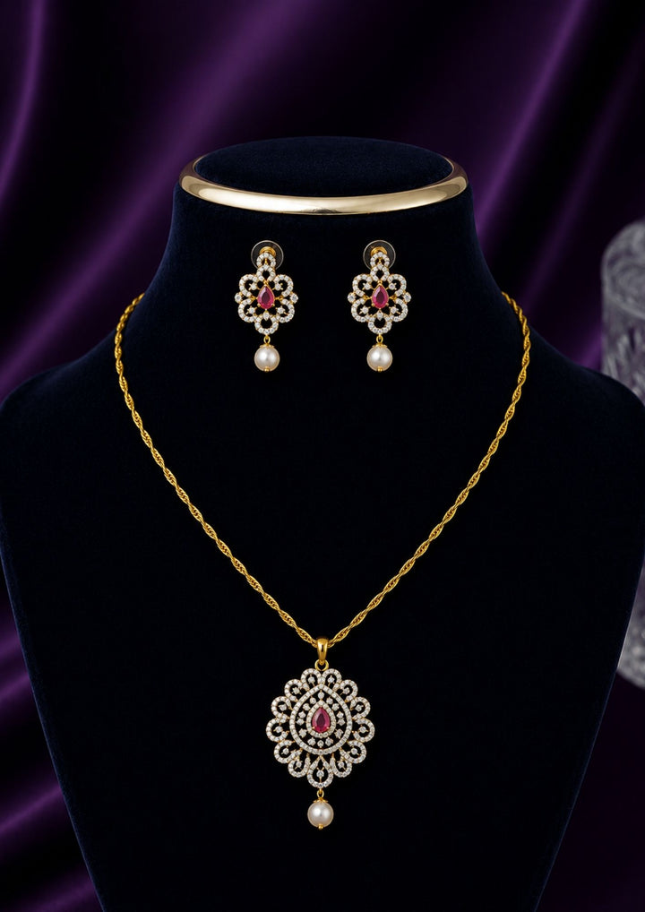 Elegant zircon diamond gold plated pendant set featuring a floral-inspired pendant designed with sparkling white zircon stones arranged in circular patterns. The centerpiece showcases a pear-shaped emerald red stone surrounded by dazzling zircon stones, finished with a delicate pearl drop. The matching earrings mirror the same floral design with green stone and pearl danglers, Perfect for weddings, festivals, office wear, functions and its anti fade color