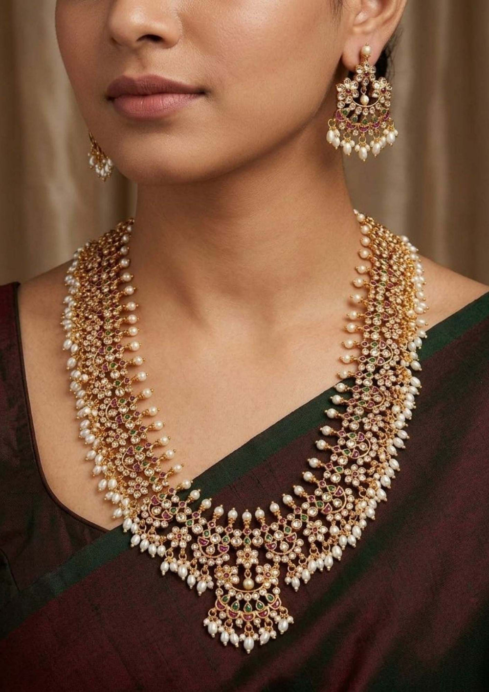 Woman wearing a detailed gold and pearl necklace with matching earrings neck closeup south indian woman festive , weeding jeweler okay for sensitive skin