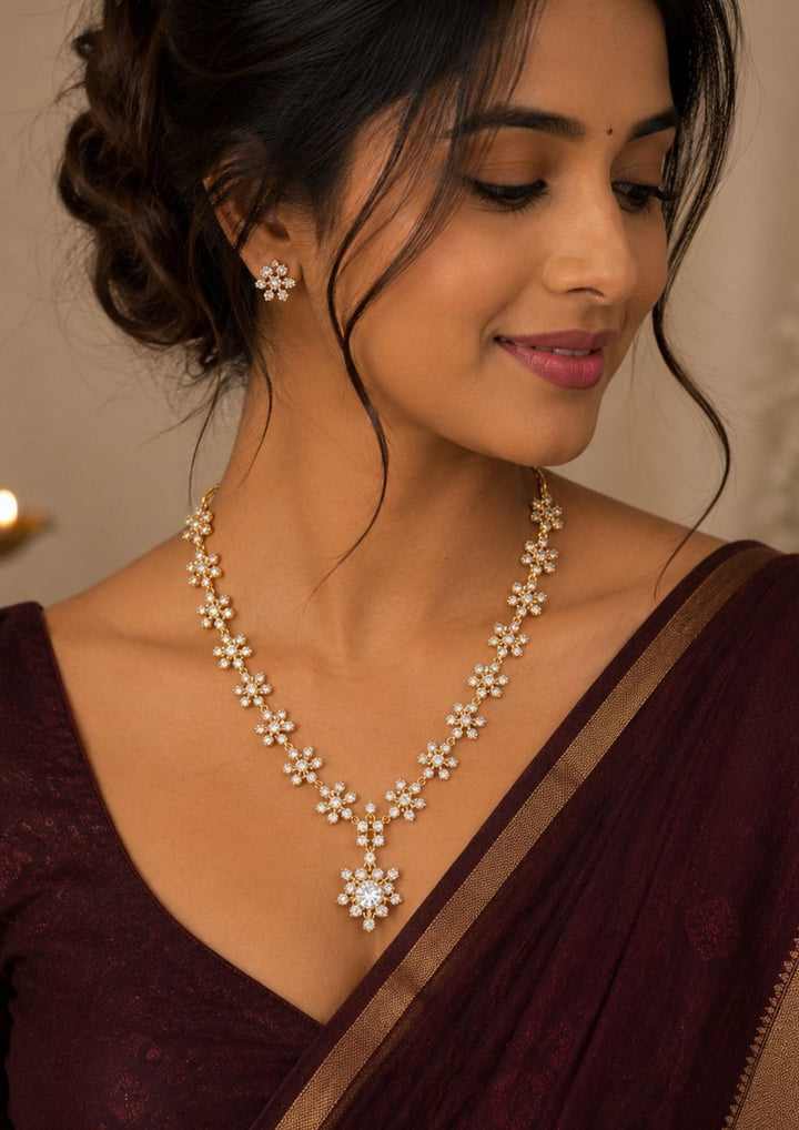 South Indian women wearing a Premium floral necklace set crafted with brilliant zircon stones, delicate flower patterns, and matching earrings for an elegant look.