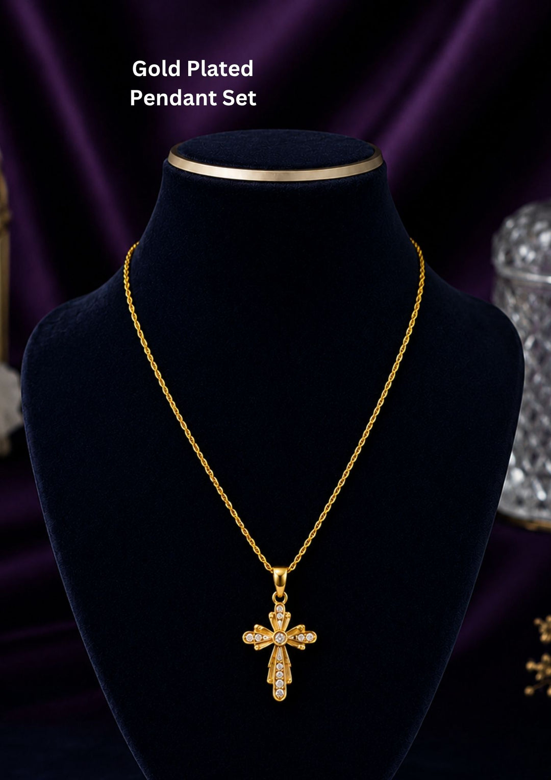 The cross has a stylized, vintage-inspired design with floriated or flared edges. It is embellished with small, clear sparkling stones (likely cubic zirconia or crystals) set along the arms of the cross and clustered at the center, giving it an eye-catching shimmer.