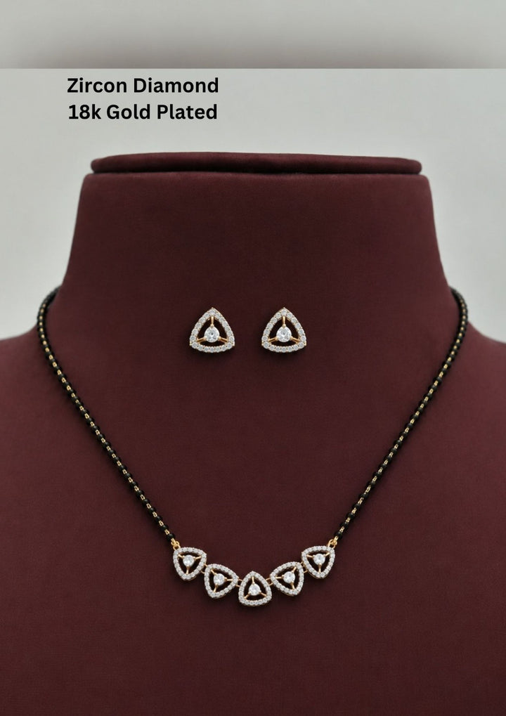 Gold plated black beads mangalsutra featuring an elegant Triangular -inspired zircon centerpiece with delicate curved detailing. Lightweight and beautifully crafted for everyday elegance, festive occasions, and gifting.