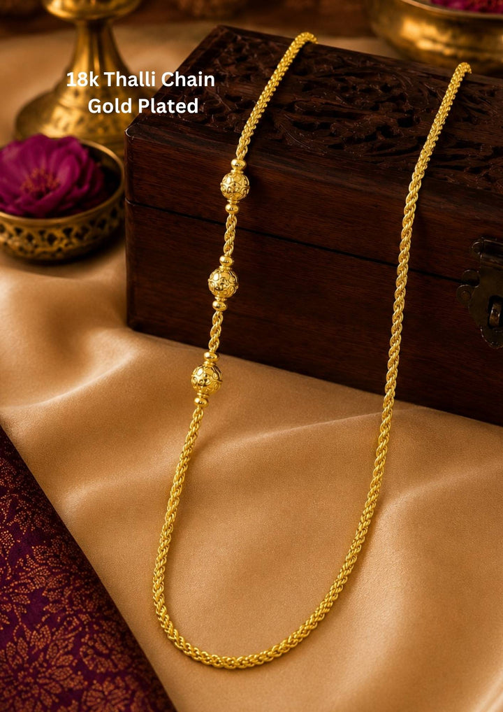 An elegant, sleek 18k gold-plated thalli chain  features a continuous, sophisticated pattern of repeating cylindrical bar links seamlessly interconnected with small circular loops, offering a clean and polished modern look. Perfect for daily wear or for pairing with your favorite pendant.