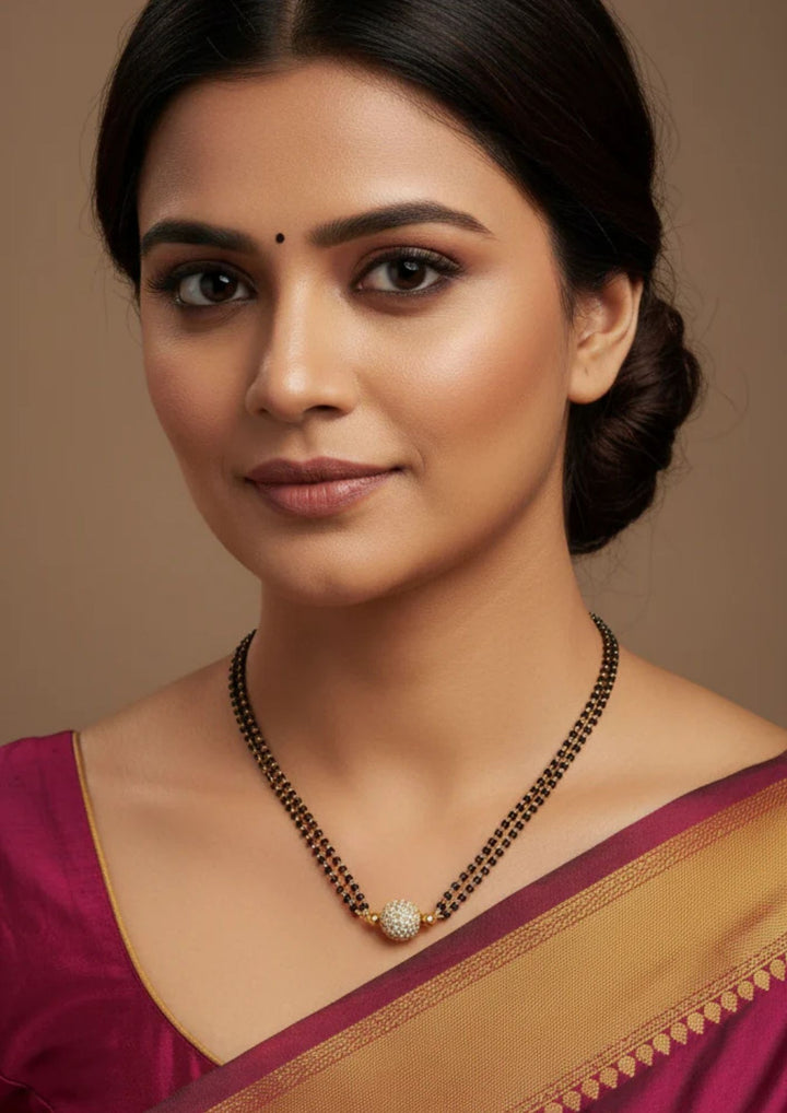 traditional south indian women wearing a ball shape manalsutra with double line it shows very clearly how it look in women's neck and can be used for gifting , daily ware and festive ware 