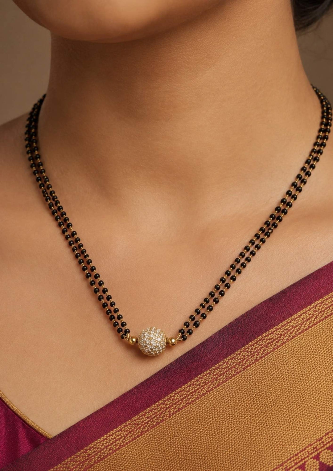 traditional women wearing a ball shape manalsutra with double line it shows very close and  how it look in women's neck and can be used for gifting , daily ware and festive ware 