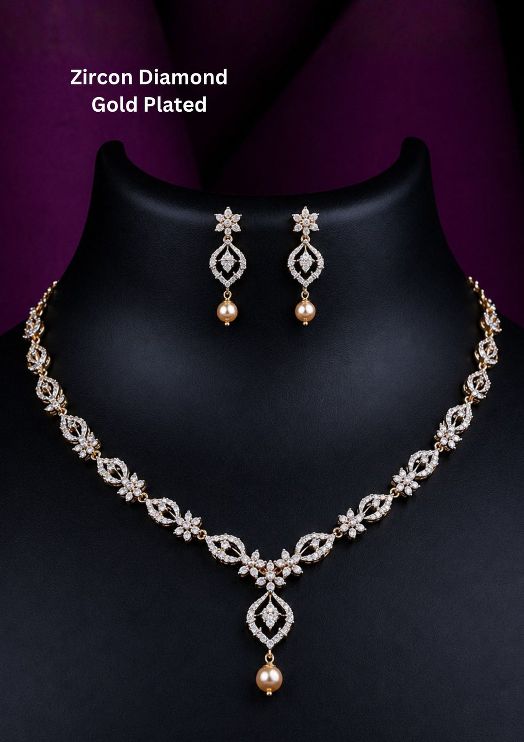 An elegant zircon diamond gold plated necklace set features a delicate V-shaped chain adorned with sparkling floral marquise stones and a central hanging pearl drop, complemented by matching floral teardrop earrings with pearl accents.