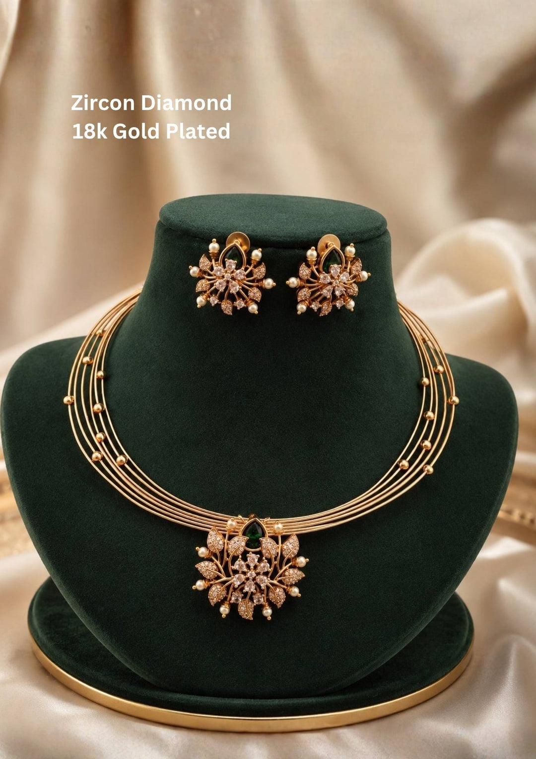 zircon diamond gold plated necklace with earrings designed with white pearls and leaf shaped gold beads with green emerald stone in middle. This necklace set has a premium gold finish, is lightweight, and comfortable to wear. Suitable for daily use, pooja, weddings, festivals, functions, and family occasions. It is sweat-proof, anti-fade, skin-friendly, and easy to wear daily