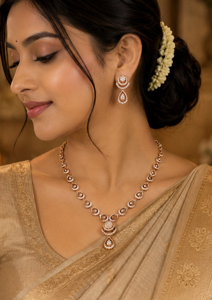Woman wearing a gold necklace and earrings 