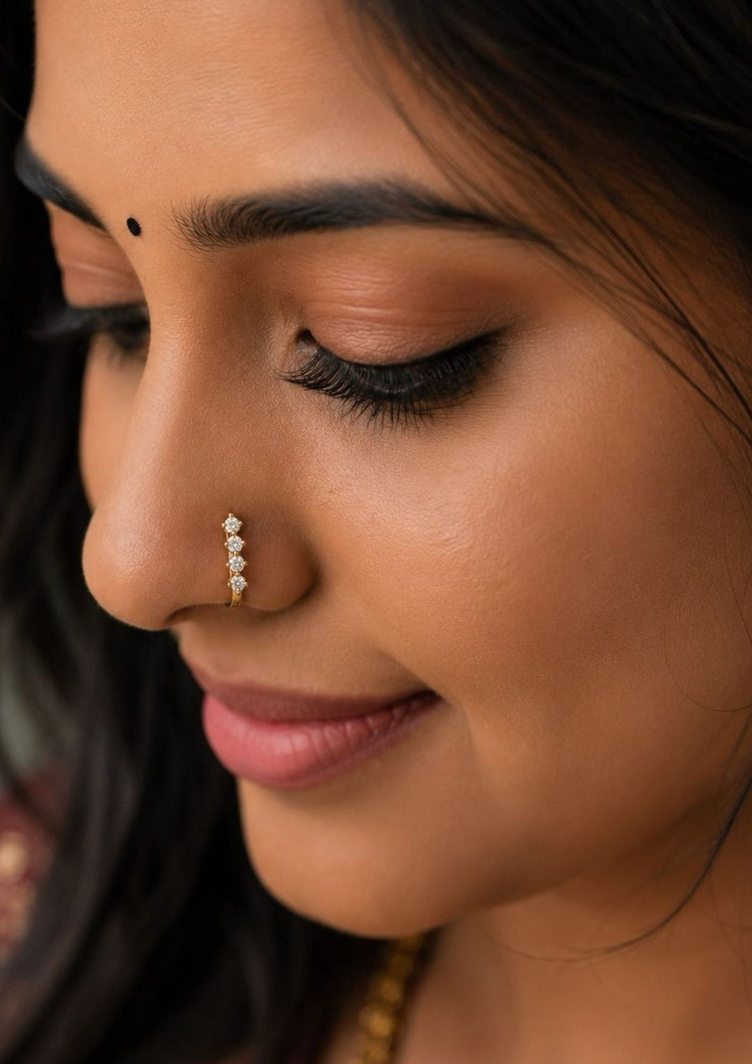 Close-up of a south indian woman's with Gold-plated nose pin design with linear design using zircon diamonds with back open its perfect for weddings, dailywear and it is antifade color.