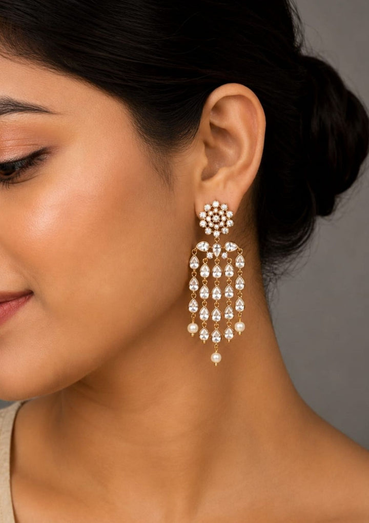  Close up offer south indian women wearing Beautiful zircon diamond gold plated chandelier earrings featuring dazzling pear-shaped zircon stones with graceful pearl drops. Perfect for weddings, receptions, parties, festive occasions, and premium gifting.